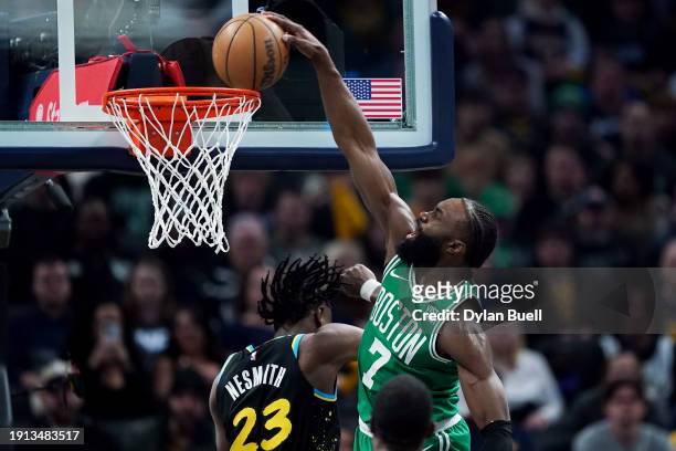 Jaylen Brown of the Boston Celtics dunks the ball over Aaron Nesmith of the Indiana Pacers in the first quarter at Gainbridge Fieldhouse on January...