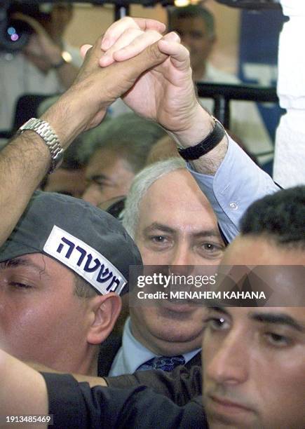 Israeli Prime Minister Benjamin Netanyahu shakes hands with a supporter during a campaign tour to the Israeli town of Ramla, south of Tel Aviv, 11...