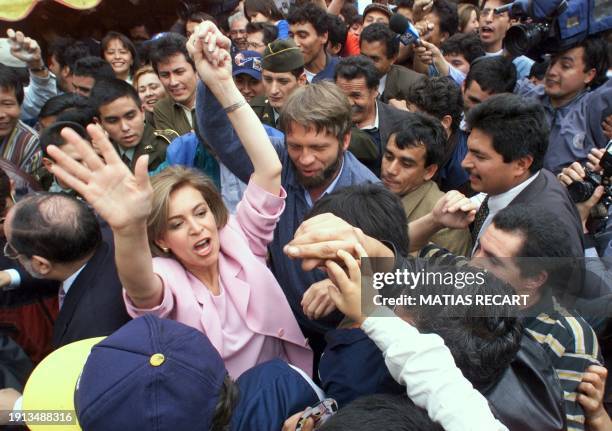 Colombian Independent presidential candidate Noemi Sanin and her vice presidential running mate Antanas Mockus are surrounded by supporters 31 May in...