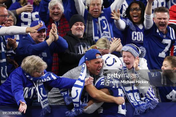 Jonathan Taylor of the Indianapolis Colts celebrates with fans after a touchdown during the third quarter against the Houston Texans at Lucas Oil...