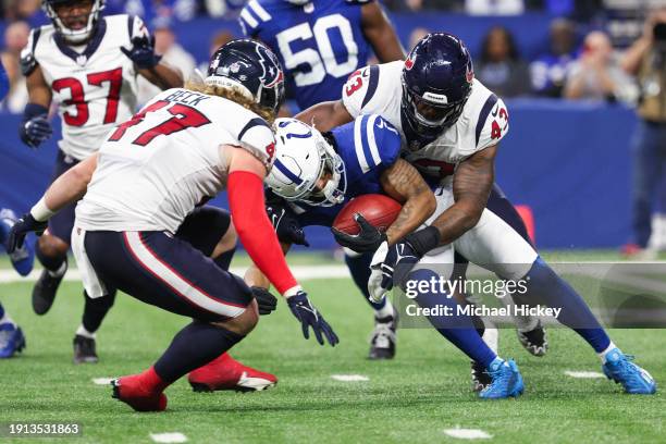 Josh Downs of the Indianapolis Colts is tackled by Neville Hewitt of the Houston Texans during the third quarter at Lucas Oil Stadium on January 06,...