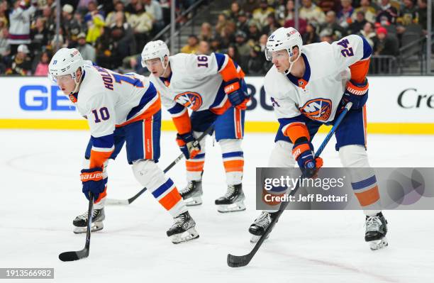 Simon Holmstrom, Scott Mayfield, and Julien Gauthier of the New York Islanders line up during the first period against the Vegas Golden Knights at...