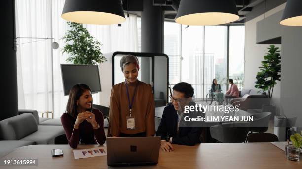 engagement between a diverse and inclusive asian business team - colleague engagement stock pictures, royalty-free photos & images