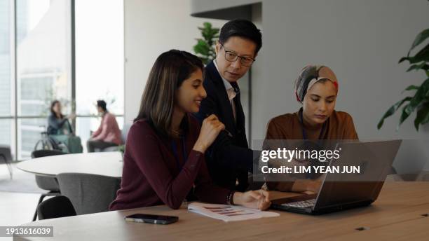 engagement between a diverse and inclusive asian business team - colleague engagement stock pictures, royalty-free photos & images