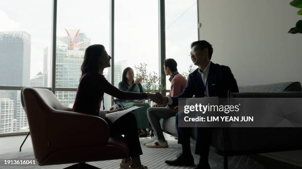 engagement between a diverse and inclusive asian business team - colleague engagement stock pictures, royalty-free photos & images