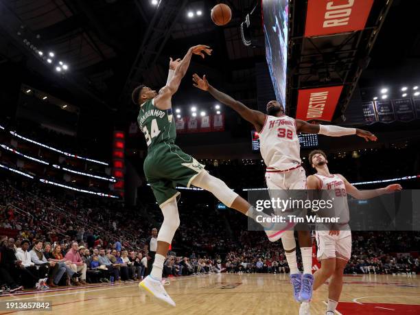 Giannis Antetokounmpo of the Milwaukee Bucks shoots the ball while defended by Jeff Green of the Houston Rockets in the second half at Toyota Center...