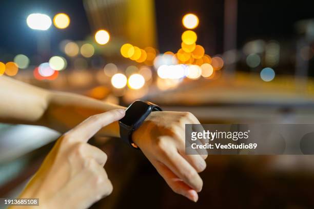 asian woman exercising in the city at night. - sport determination stock pictures, royalty-free photos & images