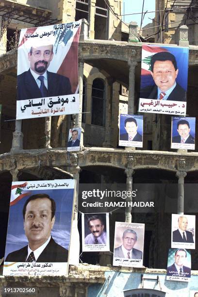 Campaign posters of candidates to the Lebanese legislative elections due later this summer cover the devastated facade of a building which was once...