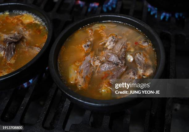 Bowls of dog meat soup are cooked at a dog meat restaurant in Daegu on January 10, 2024. South Korea's parliament on January 9, passed a bill banning...