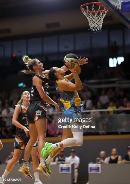 Alex Wilson of the Spirit drives to the basket against Cassandra Brown of the Fire during the WNBL match between Bendigo Spirit and Townsville Fire...