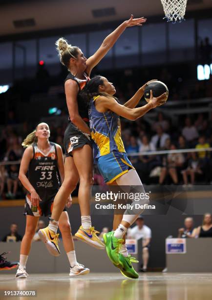 Alex Wilson of the Spirit drives to the basket against Cassandra Brown of the Fire during the WNBL match between Bendigo Spirit and Townsville Fire...