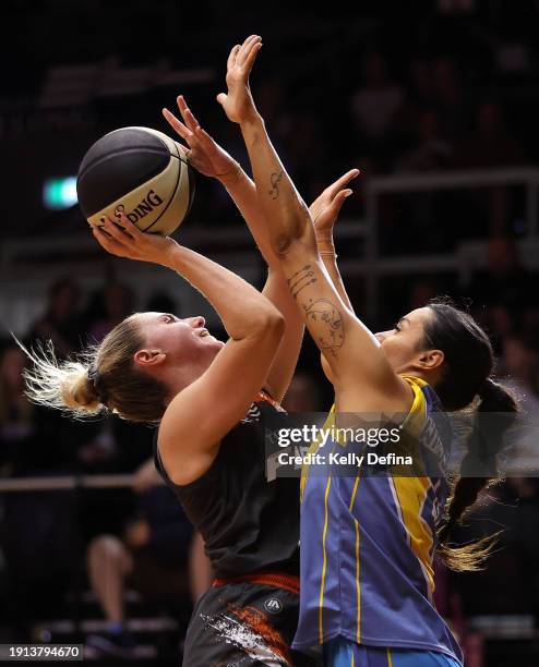 Courtney Woods of the Fire drives to the basket against Alex Wilson of the Spirit during the WNBL match between Bendigo Spirit and Townsville Fire at...