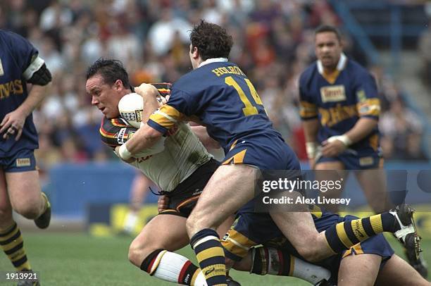 Stuart Spruce of the Bradford Bulls is tackled by Graham Holroyd of the Leeds Rhinos during the Challenge Cup Semi-Final at the McAlpine Stadium,...