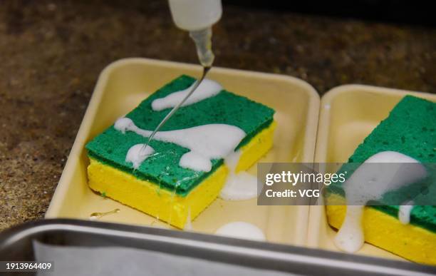 Staff member makes sponge cakes, which look like scouring pads, at Yunnan cuisine restaurant on January 6, 2024 in Hangzhou, Zhejiang Province of...