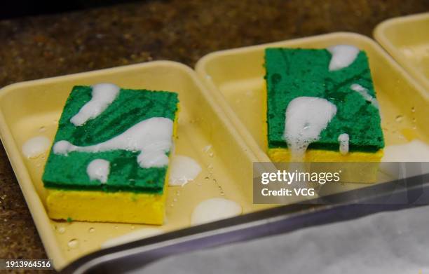 Staff member makes sponge cakes, which look like scouring pads, at Yunnan cuisine restaurant on January 6, 2024 in Hangzhou, Zhejiang Province of...