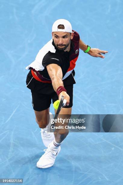 Grigor Dimitrov of Bulgaria plays a backhand in his final match against Holger Rune of Denmark during day eight of the 2024 Brisbane International at...
