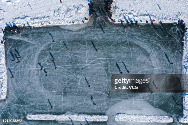Aerial view of people enjoying ice skating at a natural ice rink on January 6, 2024 in Shenyang, Liaoning Province of China.
