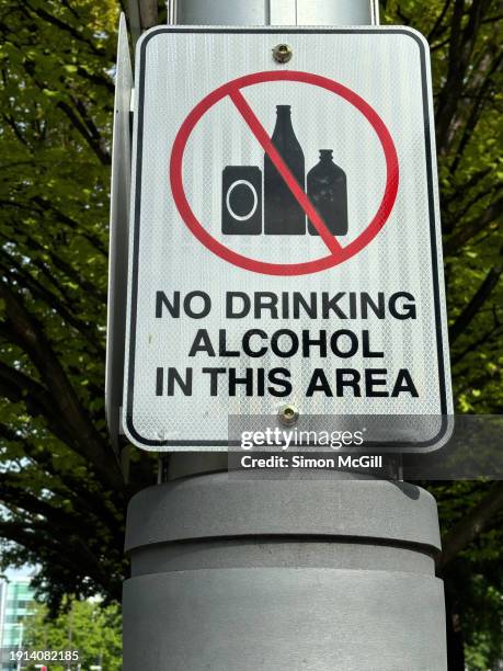 "no drinking alcohol in this area' warning sign in a public park - alcohol forbidden stock pictures, royalty-free photos & images