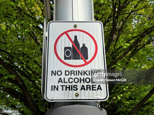 "no drinking alcohol in this area' warning sign in a public park - alcohol forbidden stock pictures, royalty-free photos & images