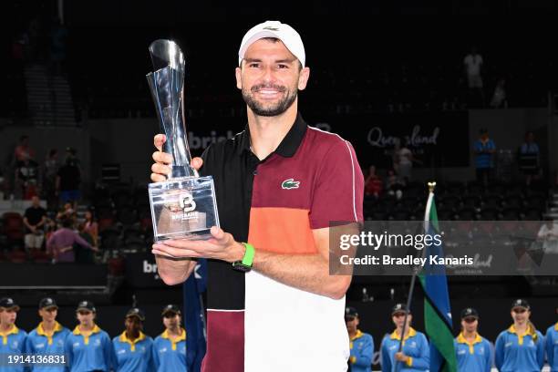 Grigor Dimitrov of Bulgaria poses with the trophy after winning his final match against Holger Rune of Denmark during day eight of the 2024 Brisbane...