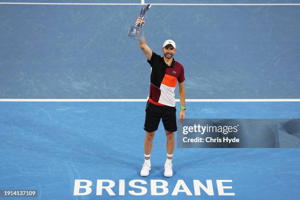 Grigor Dimitrov of Bulgaria holds the winners trophy after his final match against Holger Rune of Denmark during day eight of the 2024 Brisbane...