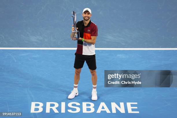 Grigor Dimitrov of Bulgaria holds the winners trophy after his final match against Holger Rune of Denmark during day eight of the 2024 Brisbane...