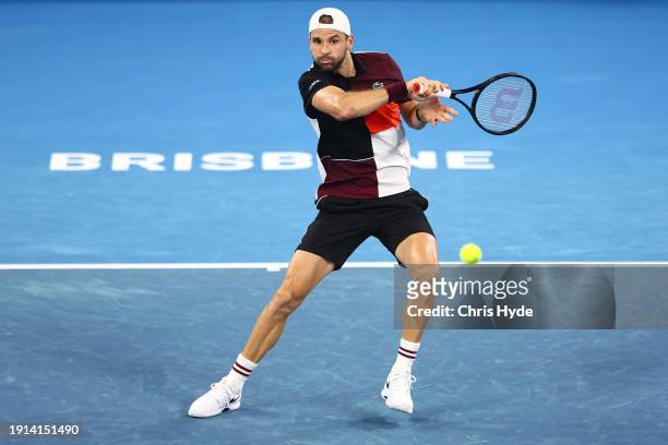 Grigor Dimitrov of Bulgaria plays a forehand in his final match against Holger Rune of Denmark during day eight of the 2024 Brisbane International at...