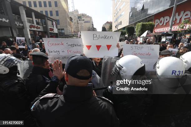 Police take security measures as scores of Palestinians demonstrate in the West Bank city of Ramallah on Wednesday against a visit by US Secretary of...