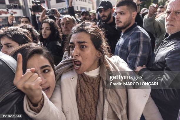 Protester reacts as demonstrators are confronted by Palestinian Authority security forces during a protest held in Ramallah as US Secretary of State...