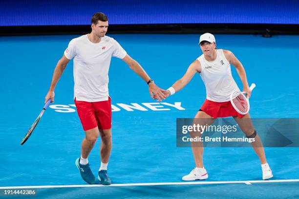 Hubert Hurkacz of Poland and Iga Swiatek of Poland celebrate winning a point in their finals match against Alexander Zverev of Germany and Laura...