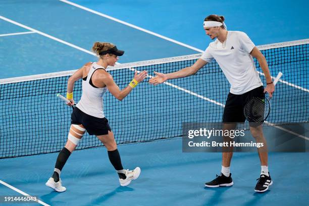 Alexander Zverev of Germany and Laura Siegemund of Germany celebrate winning a point in their finals match against Hubert Hurkacz of Poland and Iga...