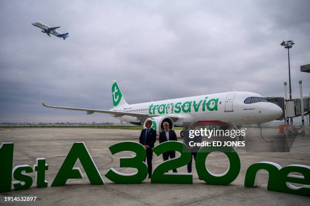 Airbus Executive Vice President Sales Benoit de Saint-Exupery , Transavia France CEO Olivier Mazzucchelli , and Avolon CEO Andy Cronin watch as an...