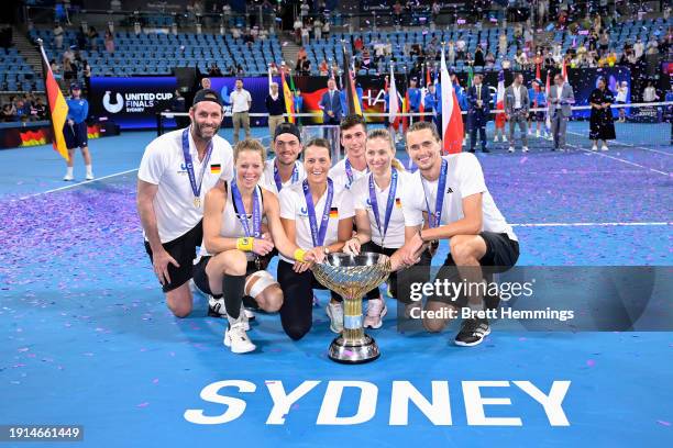 Alexander Zverev of Germany and Laura Siegemund of Germany hold the United Cup trophy aloft with Germany Team Captain Torben Beltz, Angelique Kerber...