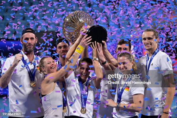 Alexander Zverev of Germany and Laura Siegemund of Germany hold the United Cup trophy aloft with Germany Team Captain Torben Beltz, Angelique Kerber...