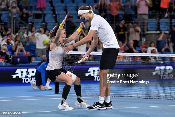 Alexander Zverev of Germany and Laura Siegemund of Germany celebrate winning their final doubles match against Iga Swiatek of Poland and Hubert...