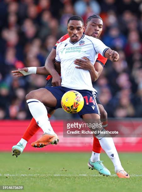 Victor Adeboyejo of Bolton Wanderers is challenged by Teden Mengi of Luton Town during the Emirates FA Cup Third Round match between Luton Town and...