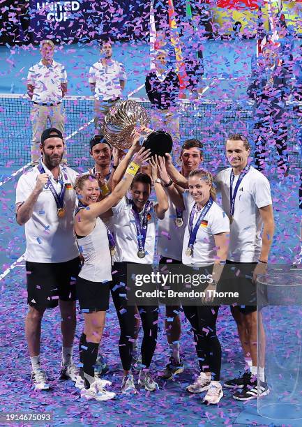 Alexander Zverev of Germany and Laura Siegemund of Germany hold the United Cup trophy aloft with Germany Team Captain Torben Beltz, Angelique Kerber...