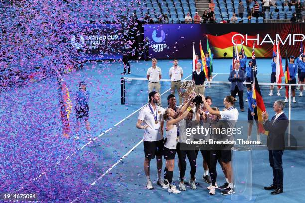 Alexander Zverev of Germany and Laura Siegemund of Germany hold the United Cup trophy aloft with Germany Team Captain Torben Beltz, Angelique Kerber...