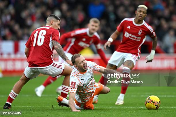 Jordan Rhodes of Blackpool and Nicolas Dominguez of Nottingham Forest battle for the ball during the Emirates FA Cup Third Round match between...