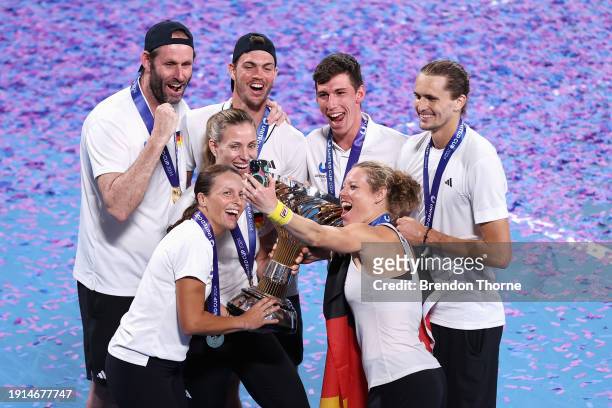 Alexander Zverev of Germany and Laura Siegemund of Germany pose for a selfie with the United Cup trophy with Germany Team Captain Torben Beltz,...