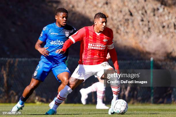Bryan Limbombe of Heracles Almelo and Patrick van Aanholt of PSV Eindhoven battle for the ball during the friendly match between PSV Eindhoven and...