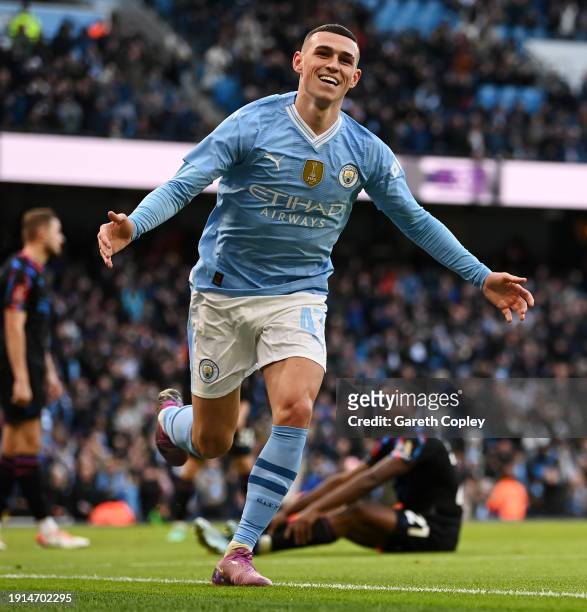 Phil Foden of Manchester City celebrates scoring his team's first goal during the Emirates FA Cup Third Round match between Manchester City and...