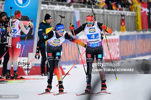 Germany's Franziska Preuss hands over to Germany's Hanna Kebinger during the women's 4x6km relay event of the IBU Biathlon World Cup in Ruhpolding,...