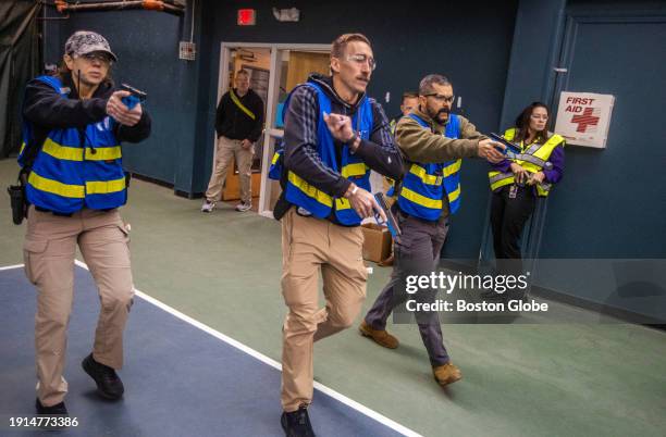 Wellesley, MA Police react to a simulated shooting situation during an active shooter training session.
