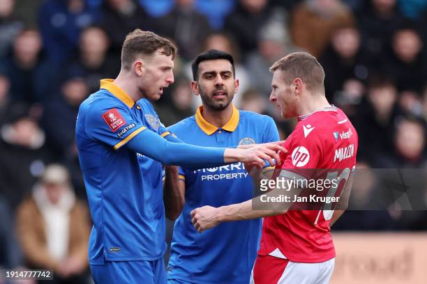 Joe Anderson of Shrewsbury Town clashes with Paul Mullin of Wrexham during the Emirates FA Cup Third Round match between Shrewsbury Town and Wrexham...