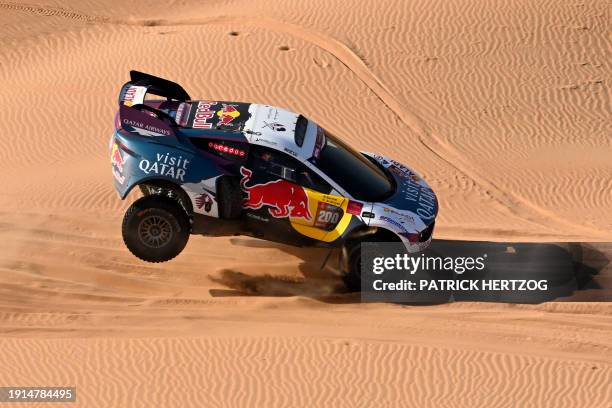 Nasser Racing's Qatari driver Nasser Al-Attiyah and his French co-driver Mathieu Baumel race their car through the dunes as they compete in Stage 5...