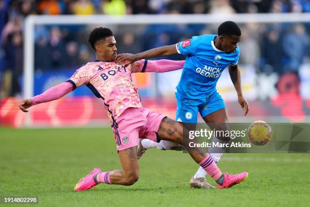 Kwame Poku of Peterborough United and Junior Firpo of Leeds United battle for the ball during the Emirates FA Cup Third Round match between...