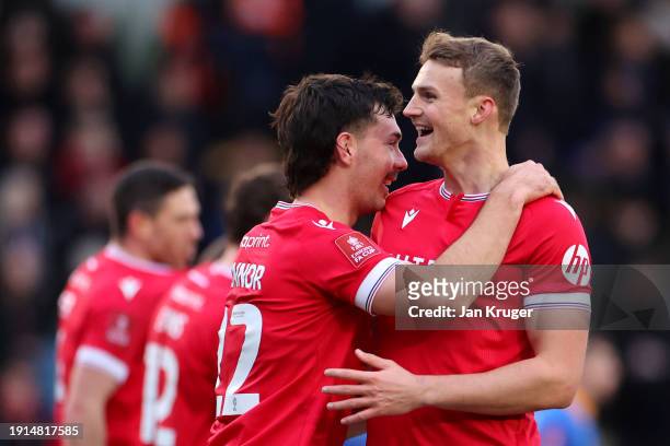 Thomas O'Connor of Wrexham celebrates scoring his team's first goal with teammate Sam Dalby during the Emirates FA Cup Third Round match between...