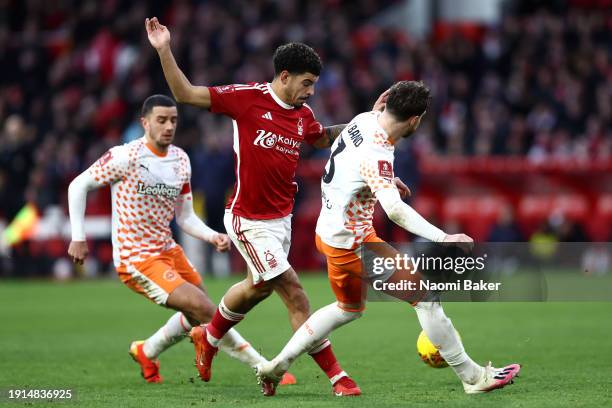 Morgan Gibbs-White of Nottingham Forest and James Husband of Blackpool battle for the ball during the Emirates FA Cup Third Round match between...