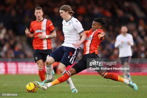 Jon Dadi Boedvarsson of Bolton Wanderers is challenged by Gabriel Osho of Luton Town during the Emirates FA Cup Third Round match between Luton Town...